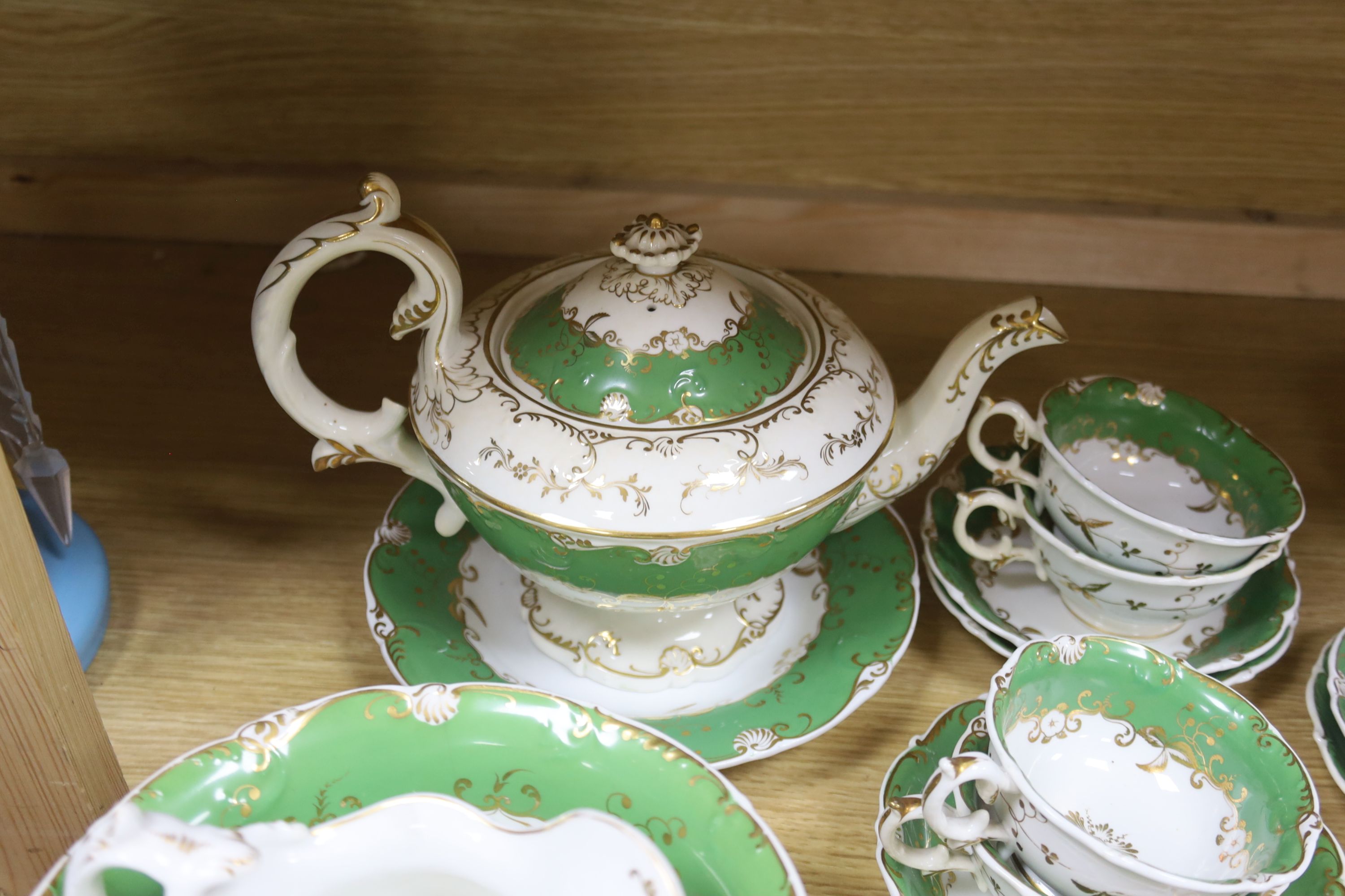 A Copeland blue and white nine cup and saucer cabaret set on stand and a 19th century Rockingham style green and gilt decorated tea ser